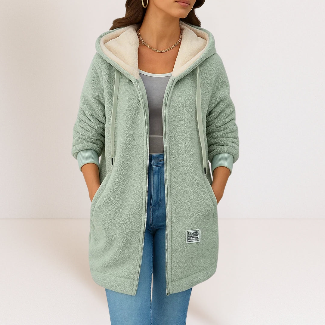 Veste femme longue à capuche, fermeture zip, poches plaquées et poignets côtelés